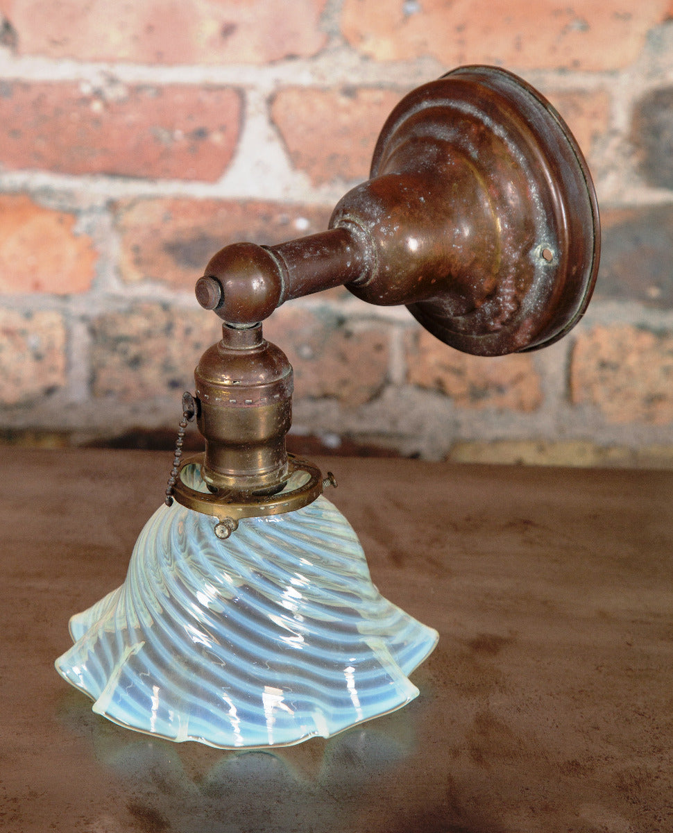 early 20th century antique american wall sconce with nicely aged patina and blue opalescent shade with ruffled edges
