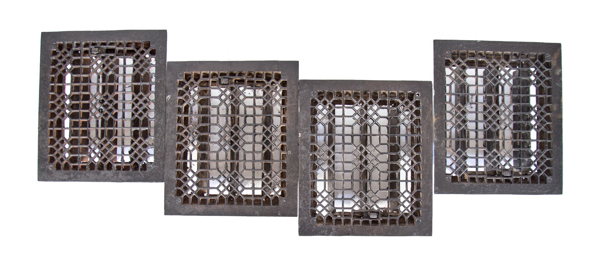 group of four original matching "indian lattice pattern" 19th century salvaged chicago cast iron louvered floor registers