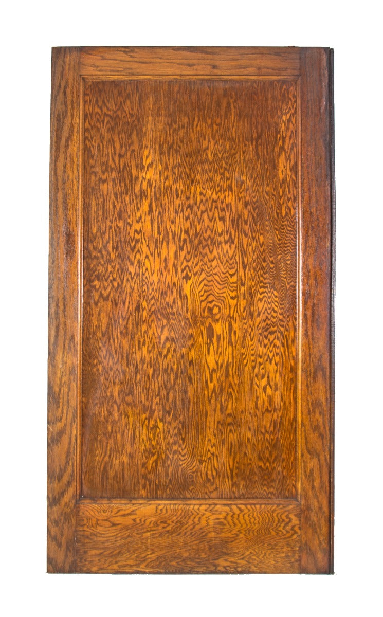 one of two mammoth early 20th century double-sided varnished oak wood residential pocket doors with original finish