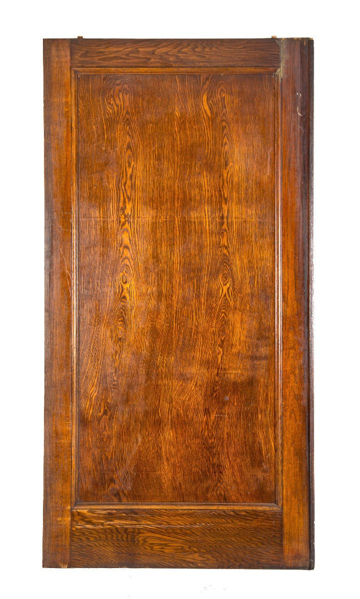 single early 20th century original varnished oak wood oversized pocket door salvaged from a chicago residence undergoing demolition