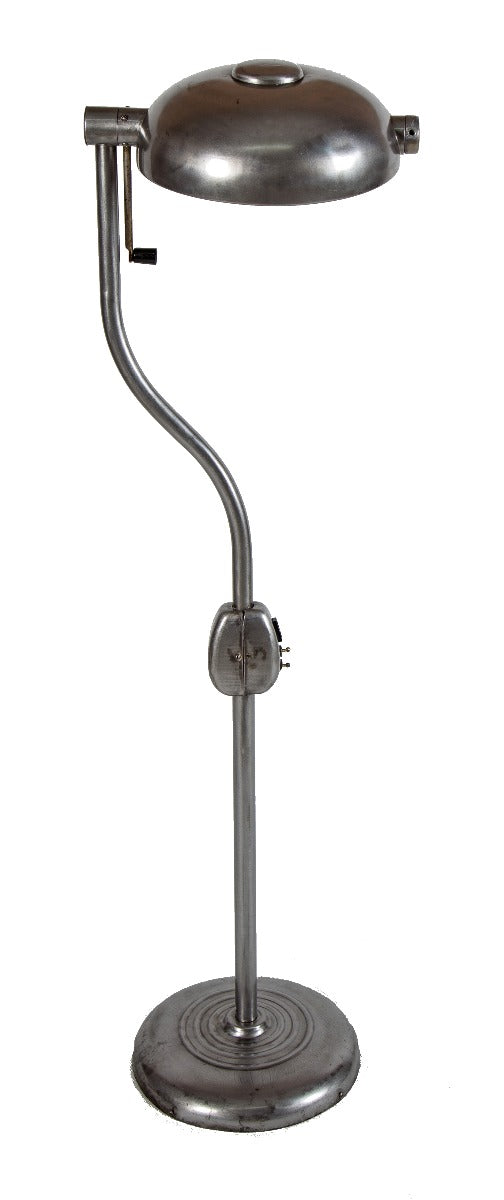 one of two matching original brushed metal hospital examination room adjustable floor lamps with pivoting handle