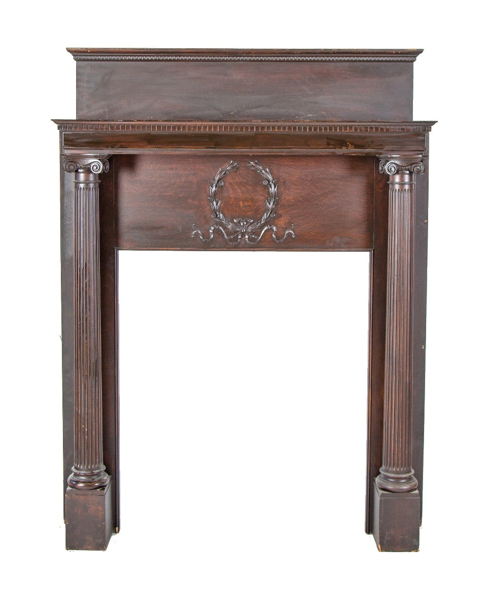 refinished oversized interior st. louis residential oak wood fireplace mantel with opposed fluted columns and laurel wreath