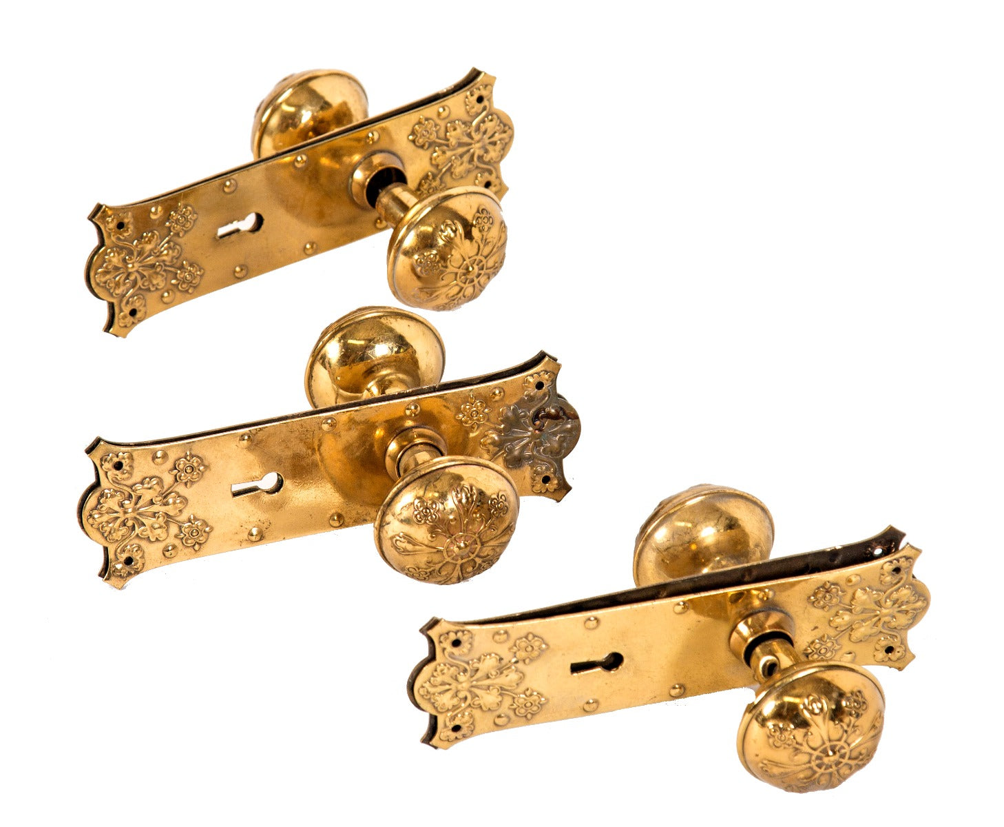 three matching sets of original late 19th or early 20th century ornamental wrought brass passage door hardware