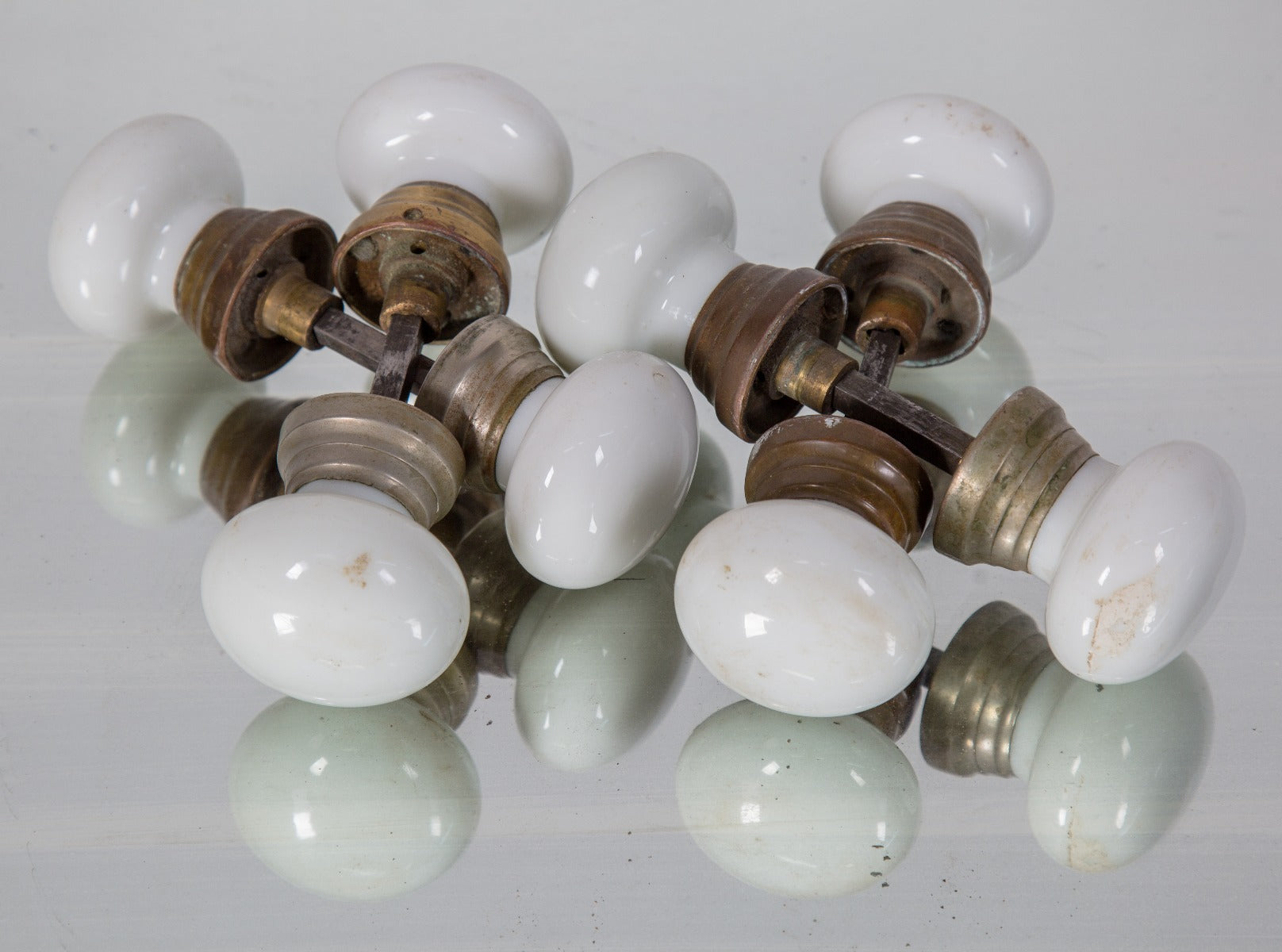 four matching original salvaged chicago antique american "mushroom" style white opalescent doorknob sets