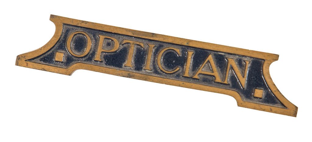 hard to find early 20th century single-sided diminutive ornamental cast brass optician's office desk plaque with blue enameled inlay