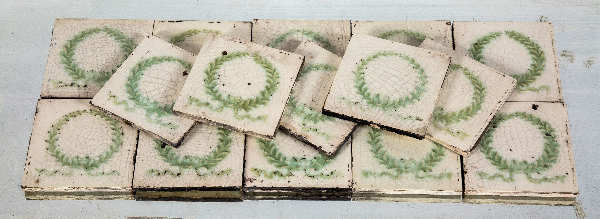 large lot of original 19th century majolica glazed salvaged chicago residential fireplace tiles with lightly embossed laurel wreaths