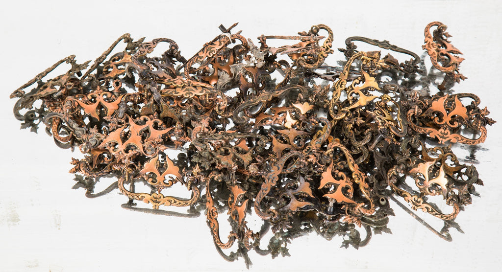 one of nearly forty matching late 19th century salvaged chicago built-in drawer cast brass drawer pulls with copper-plated finish