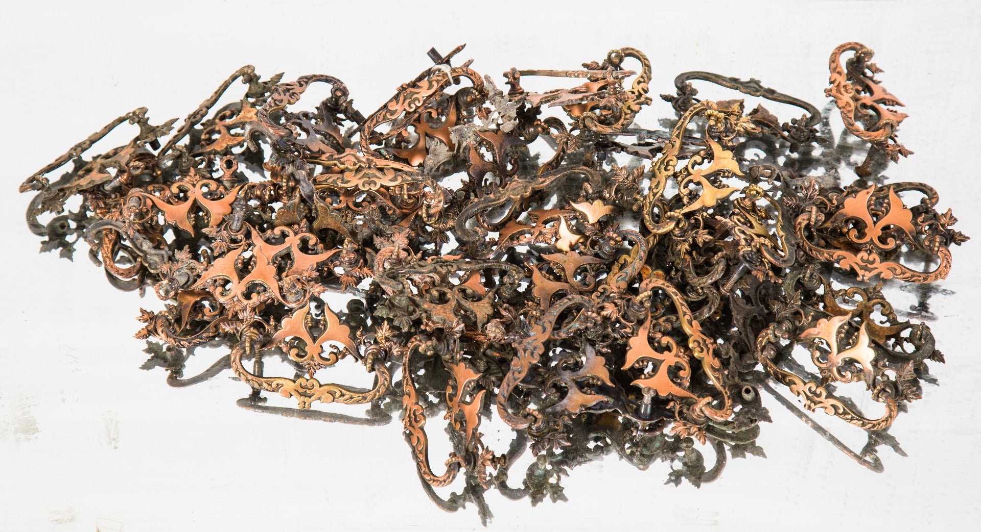 one of nearly forty matching late 19th century salvaged chicago built-in drawer cast brass drawer pulls with copper-plated finish