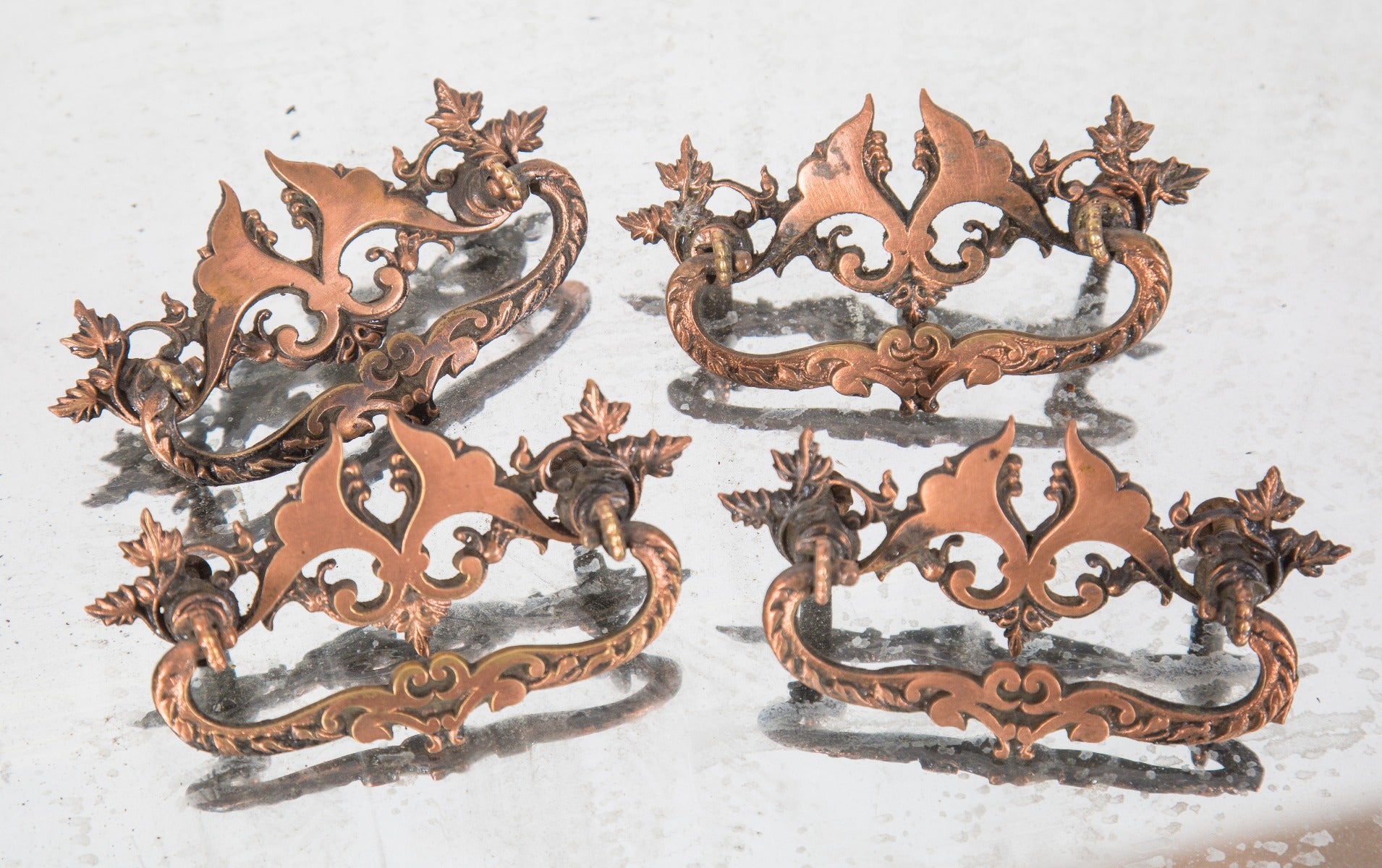 one of nearly forty matching late 19th century salvaged chicago built-in drawer cast brass drawer pulls with copper-plated finish
