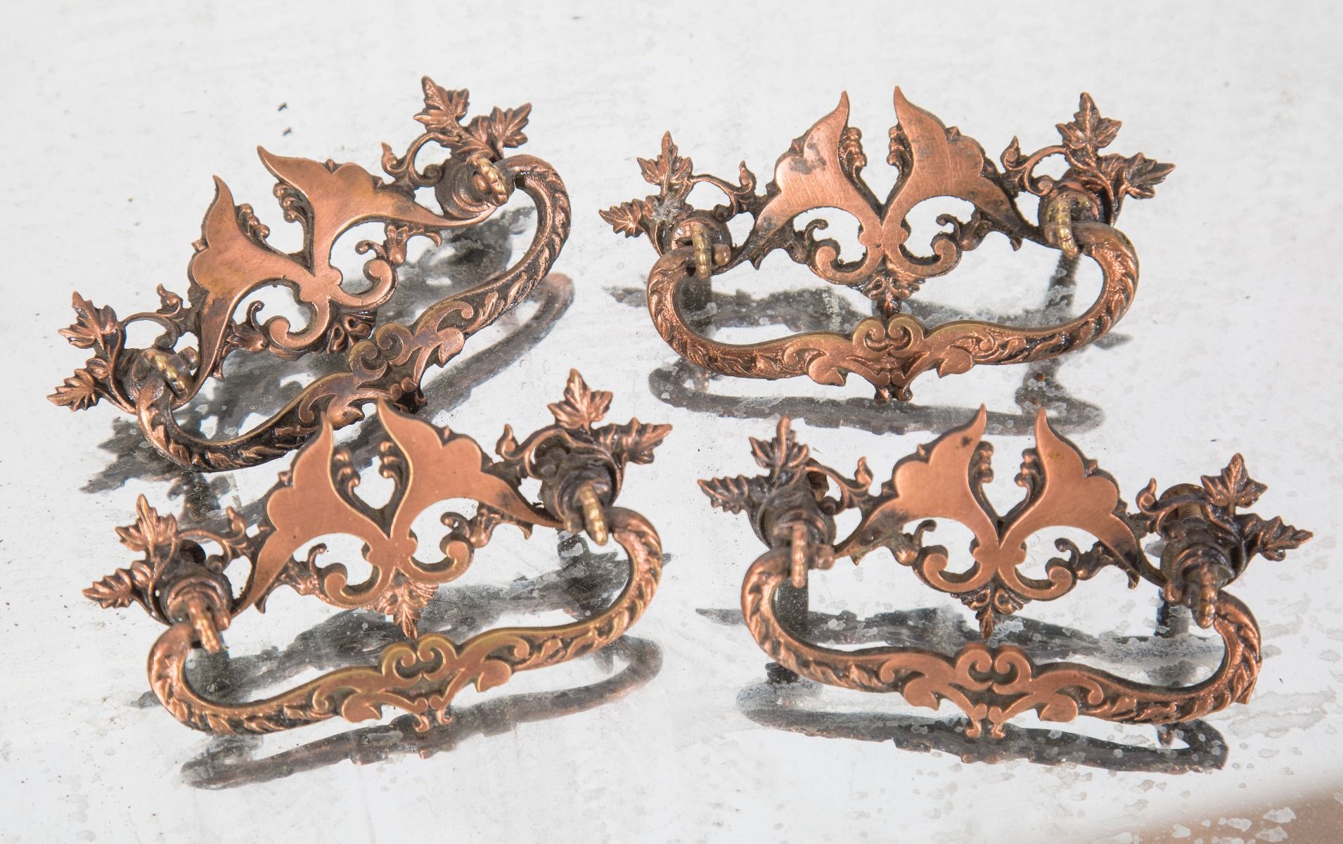 tweleve matching original late 19th or early 20th century copper-plated cast brass victorian drawer pulls