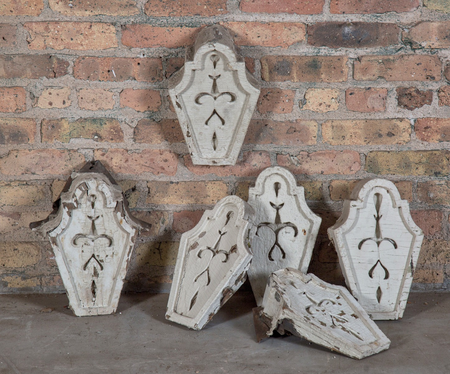 group of six matching salvaged post-fire chicago residential worker cottage keystones with deeply incised floral motifs