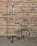 vintage american industrial three-legged cast iron and steel theater stage "ghost light" with crouse-hinds bulb guard