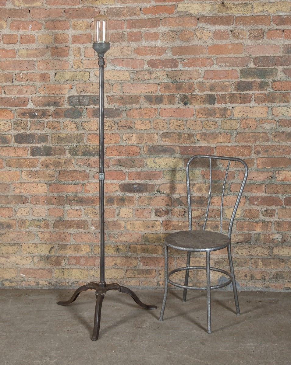 vintage american industrial three-legged cast iron and steel theater stage "ghost light" with crouse-hinds bulb guard
