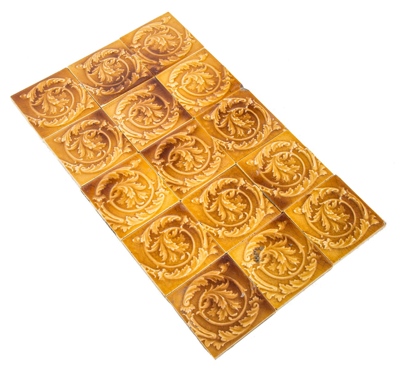 group of 15 matching original salvaged chicago 19th century butterscotch majolica glazed fireplace tiles with floral and swirl design