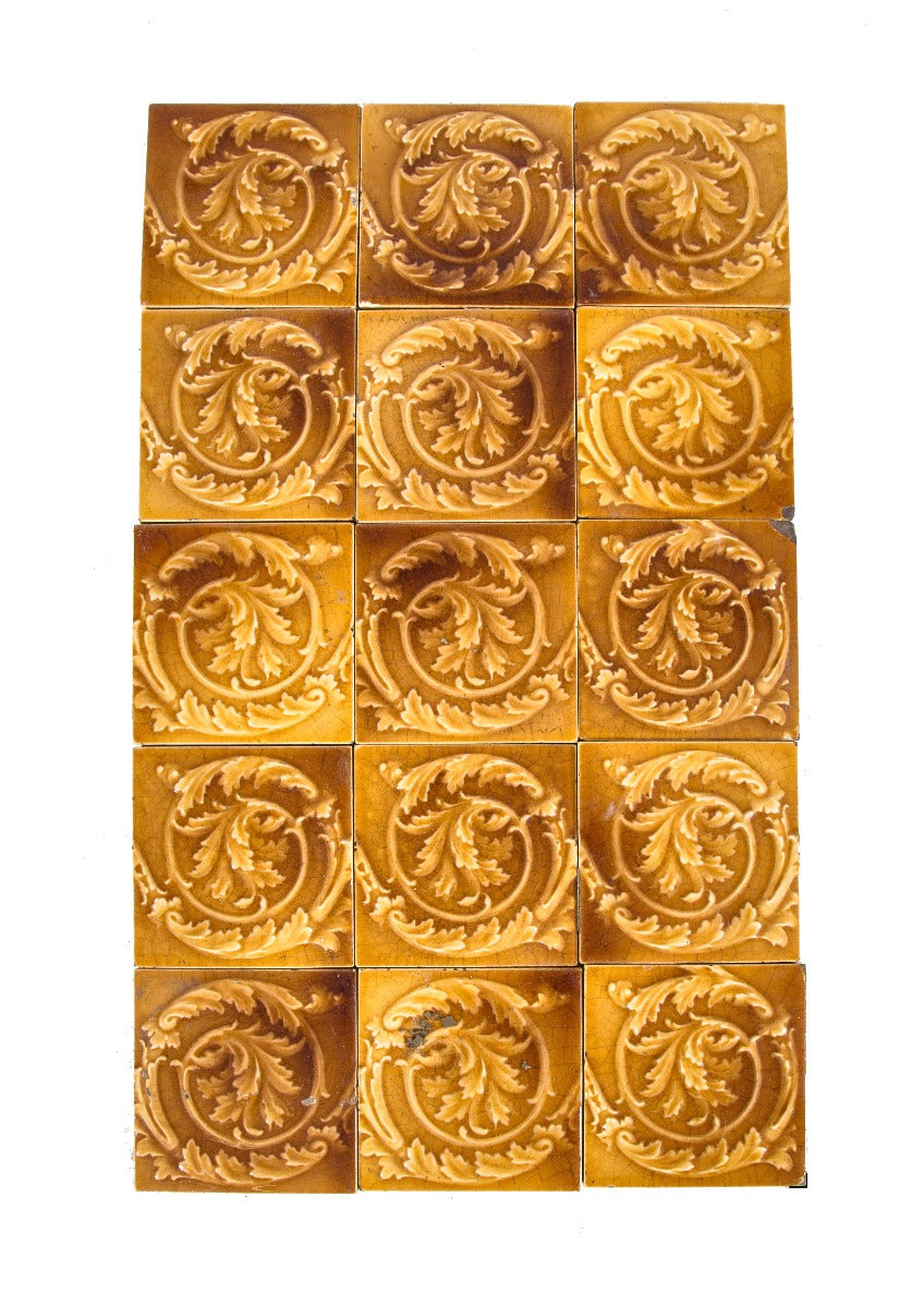 group of 15 matching original salvaged chicago 19th century butterscotch majolica glazed fireplace tiles with floral and swirl design