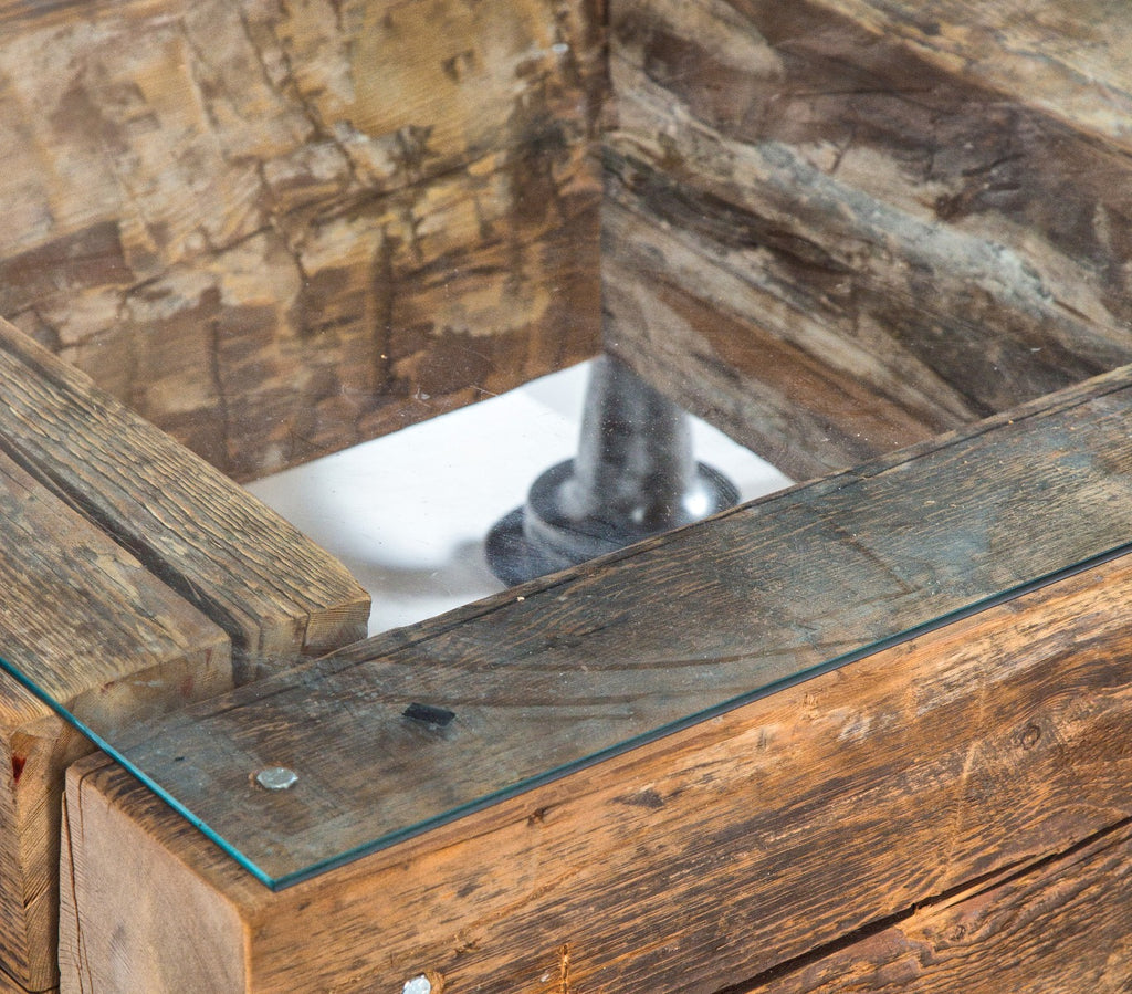 repurposed compact low-lying old growth pine wood sill plate beam coffee table with a. finkl steel flanges and beveled edge plate glass top