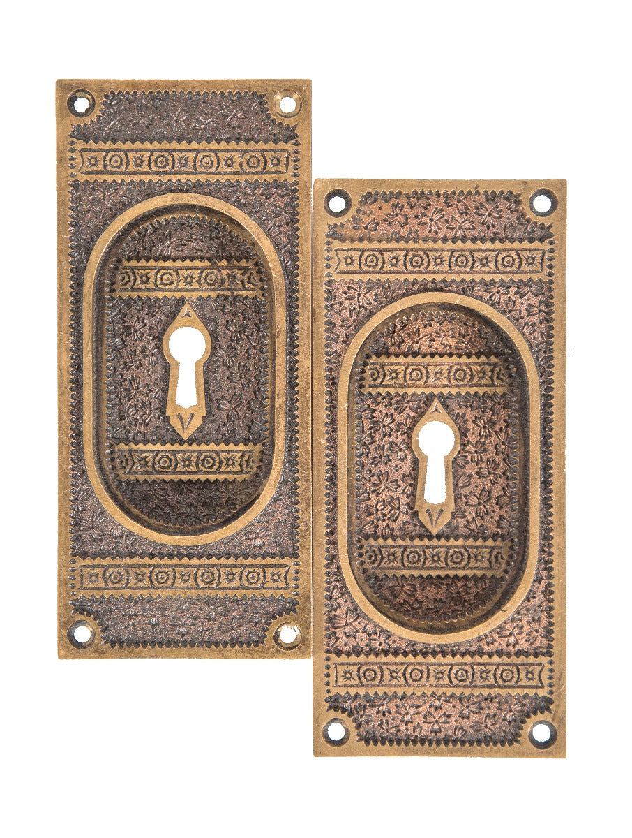 two matching original 19th century eastlake style cast bronze "ivy" pattern pocket door plates with mostly uniform patina