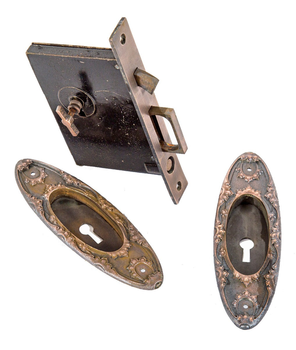 original late 19th or early 20th century salvaged chicago "louis xiii" pattern cast bronze pocket door hardware with key