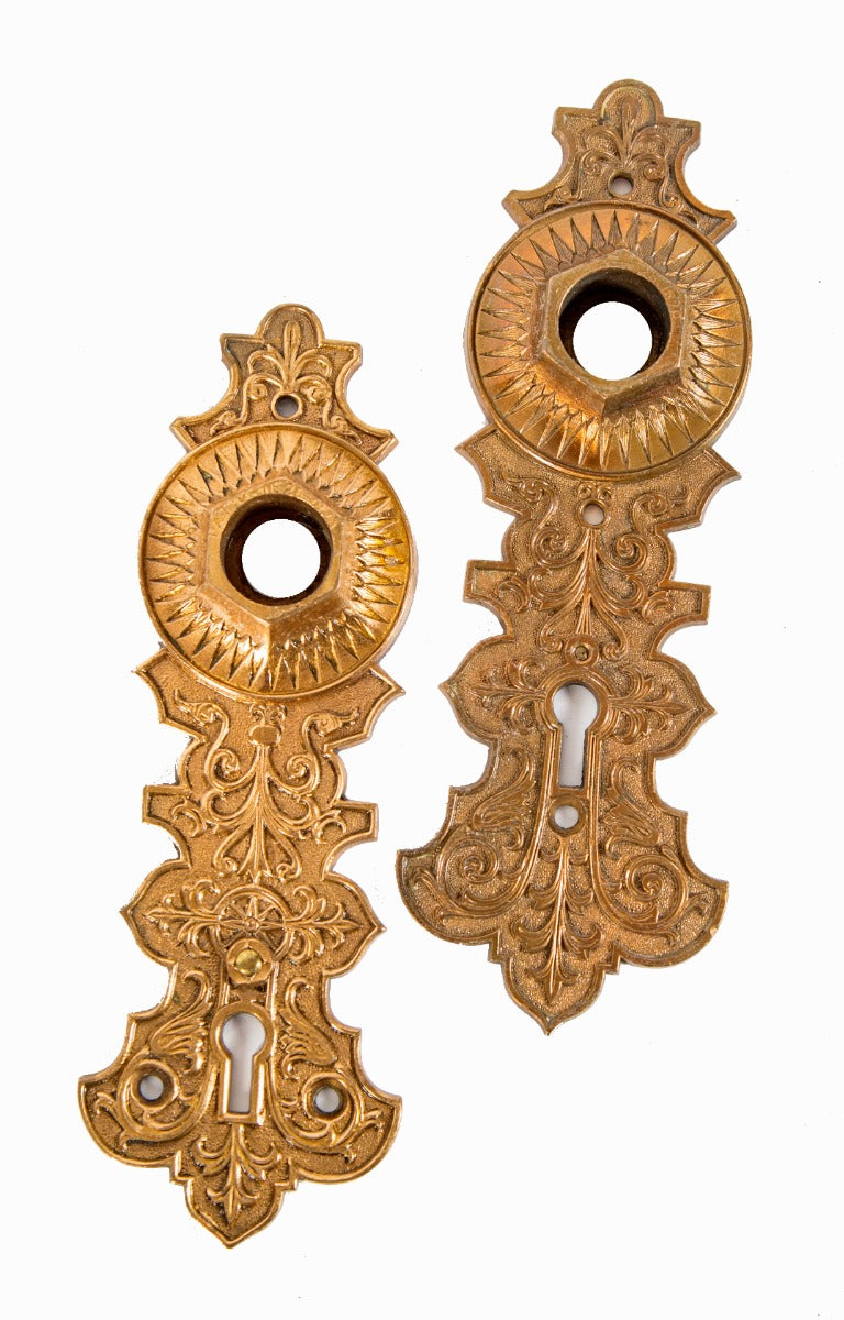 two matching 1870s high victorian-era ornamental cast bronze interior residential compression cast doorknob backplates