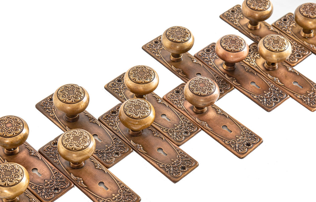 several matching salvaged chicago early 20th century cast brass "alexandria" pattern residential door hardware