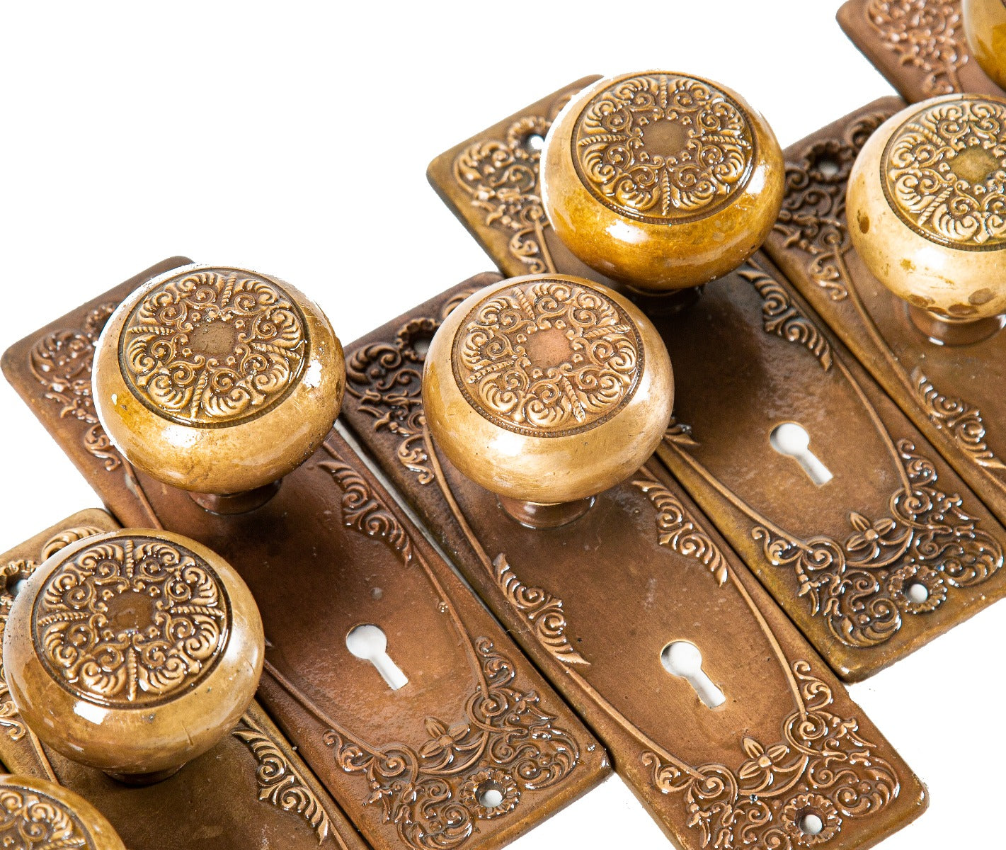 late 19th or early 20th century antique american ornamental cast brass "alexandria" pattern doorknobs and matching backplates