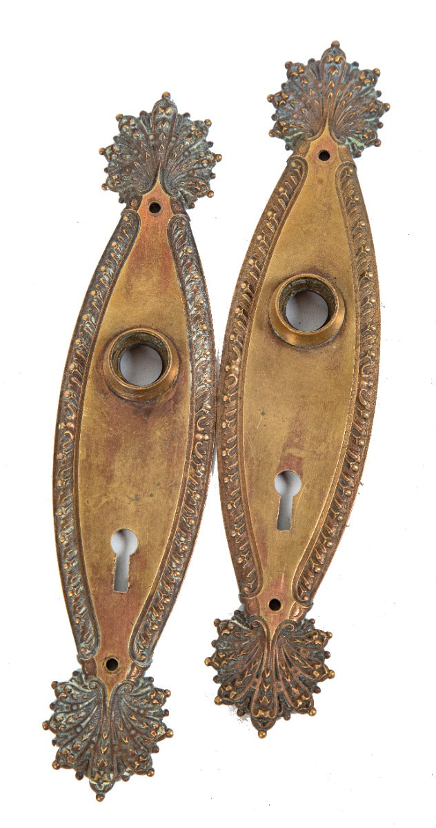 two matching early 20th century ornamental cast brass "marquise" pattern interior residential doorknob backplates