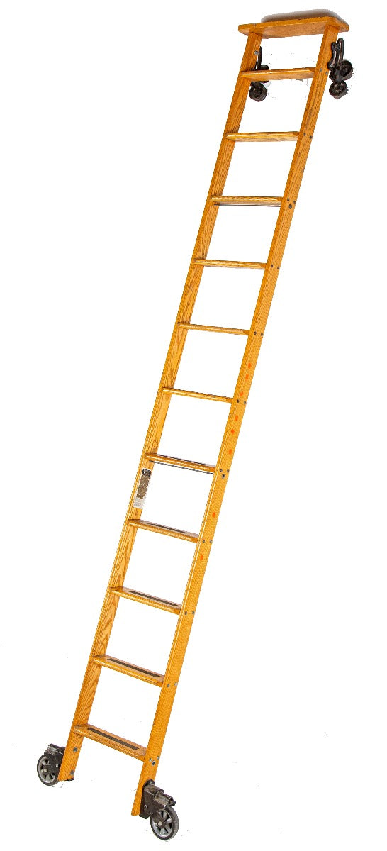 one of two original vintage american industrial fully functional "cotterman" solid oak wood chicago public library ladders rolling