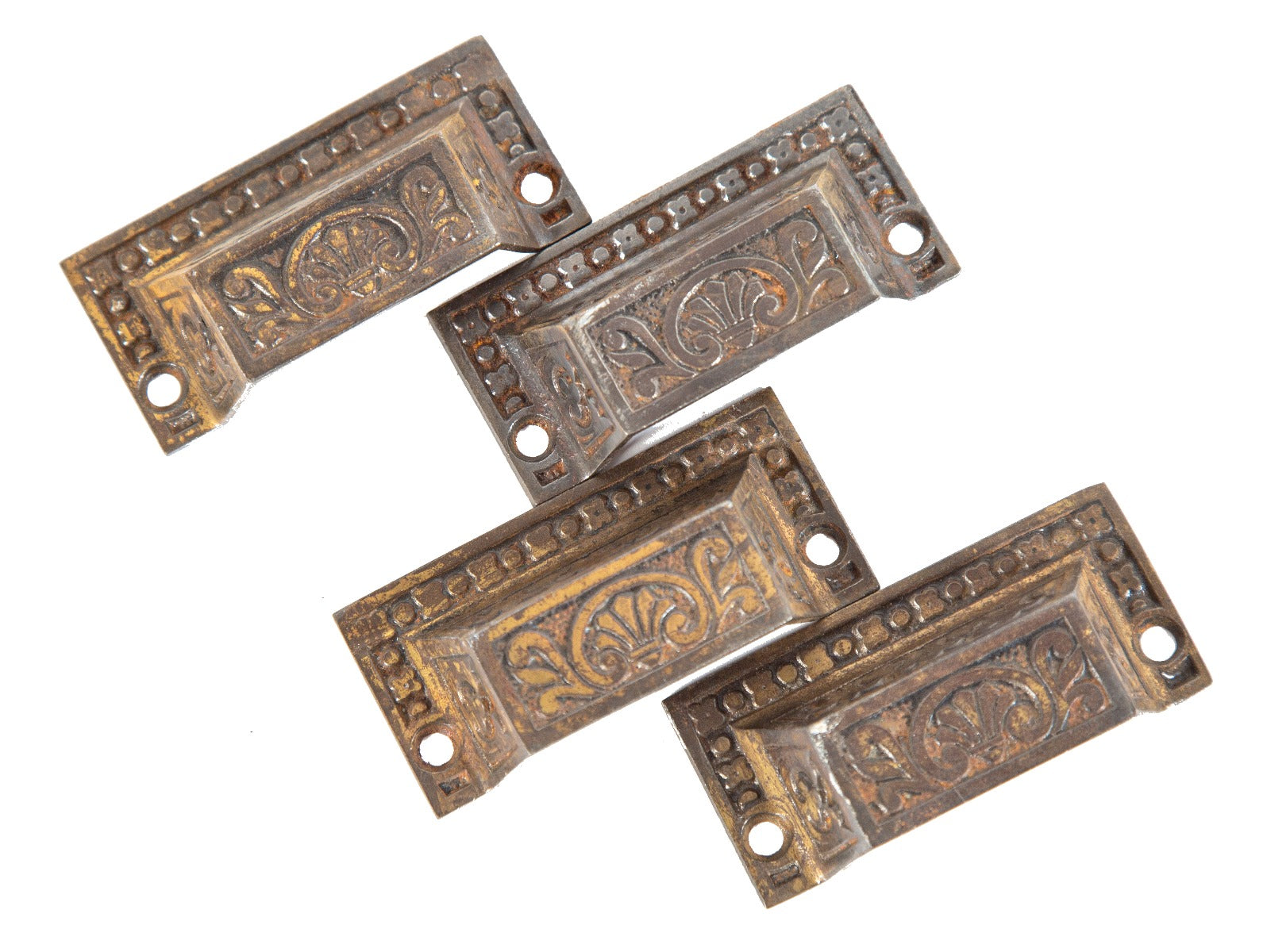 group of four matching ornamental cast iron victorian-era cabinet drawer pulls salvaged from chicago residence