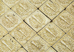 original 19th century 3 x 3 inch yellow glazed deeply embossed majolica tiles with torches and laurel wreaths