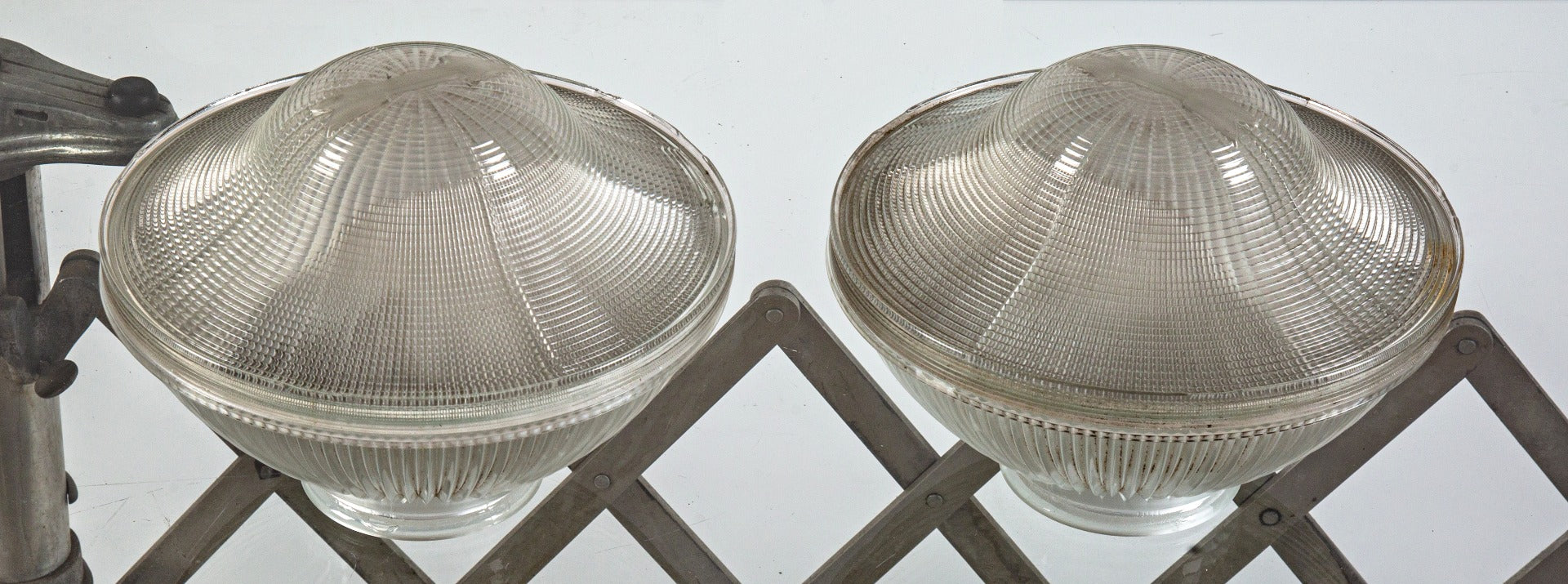 two matching original early 20th century holophane prismatic glass bowl shades with unique embossed directional arrows