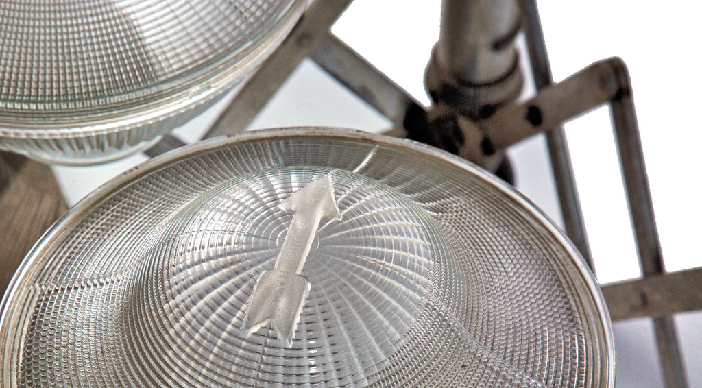 two matching original early 20th century holophane prismatic glass bowl shades with unique embossed directional arrows