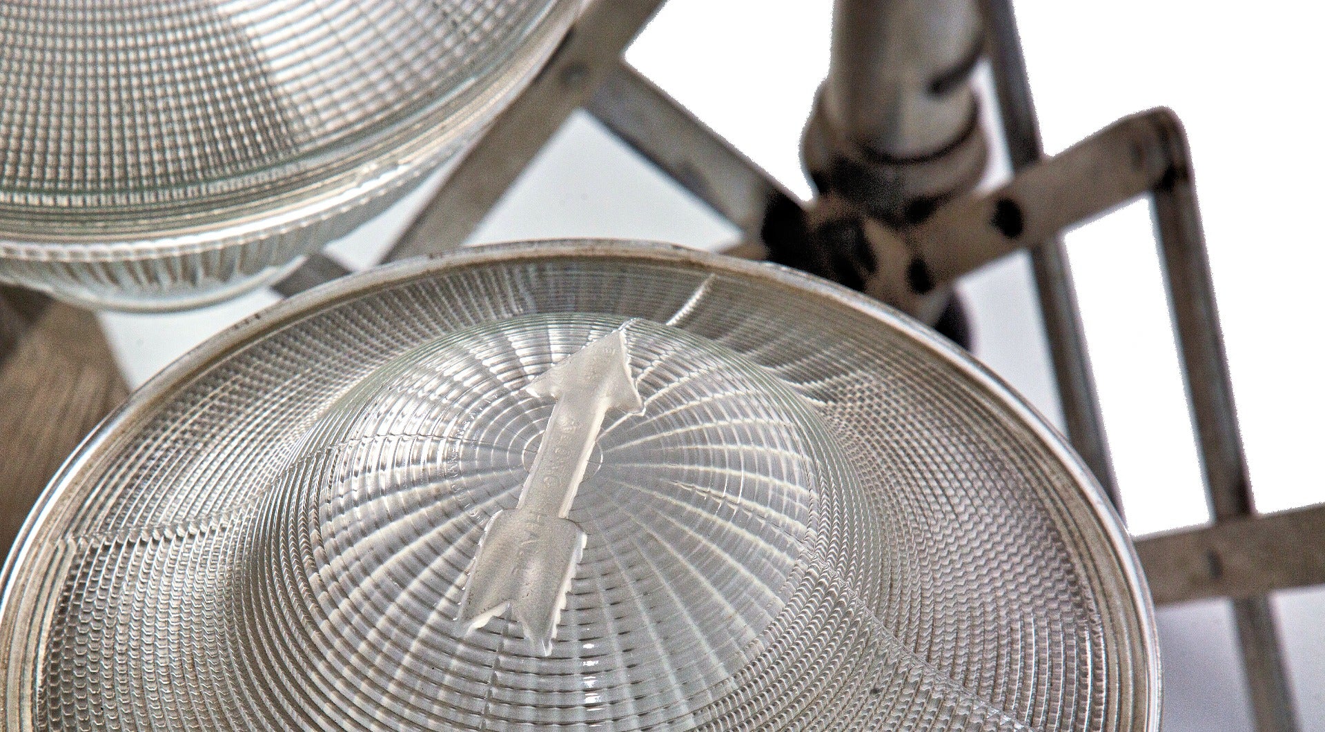 two matching original early 20th century holophane prismatic glass bowl shades with unique embossed directional arrows