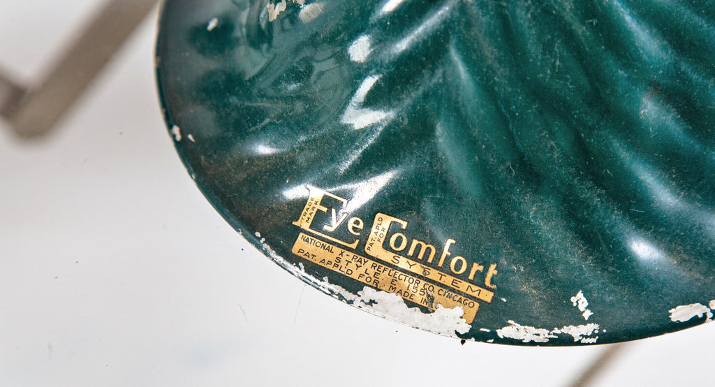 group of three green enameled national x-ray "eye comfort" ribbed glass reflectors salvaged from a chicago storefront