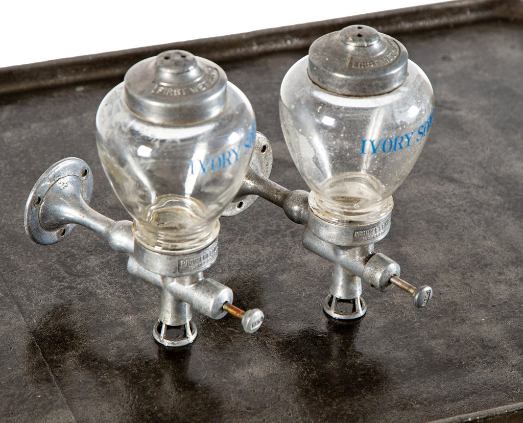 one of two identical antique american art deco wall-mount ivory soap glass dispensers with functional plunger