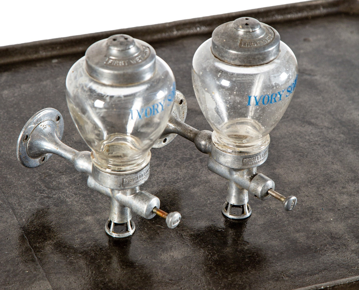 one of two identical antique american art deco wall-mount ivory soap glass dispensers with functional plunger