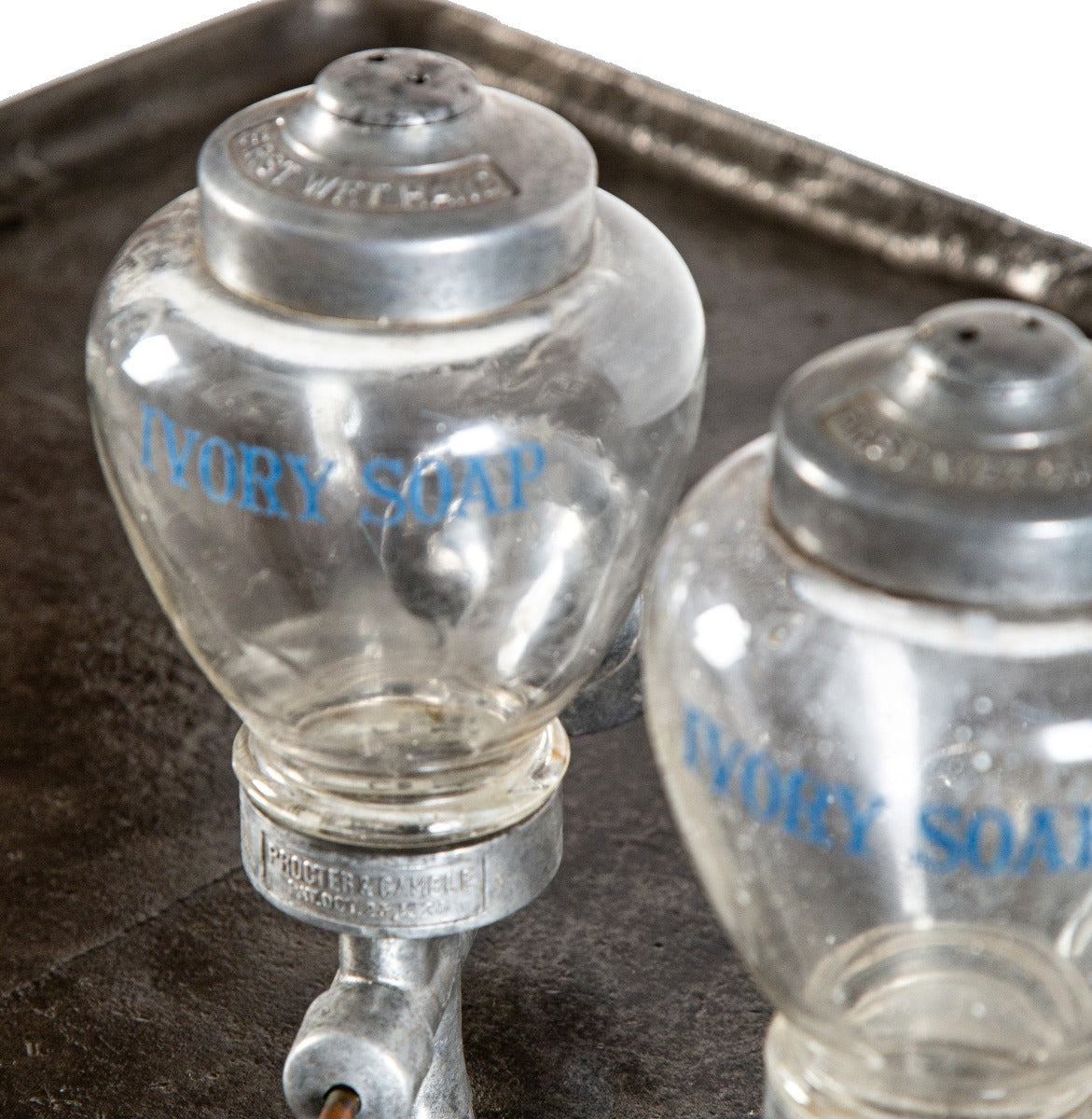 one of two identical antique american art deco wall-mount ivory soap glass dispensers with functional plunger