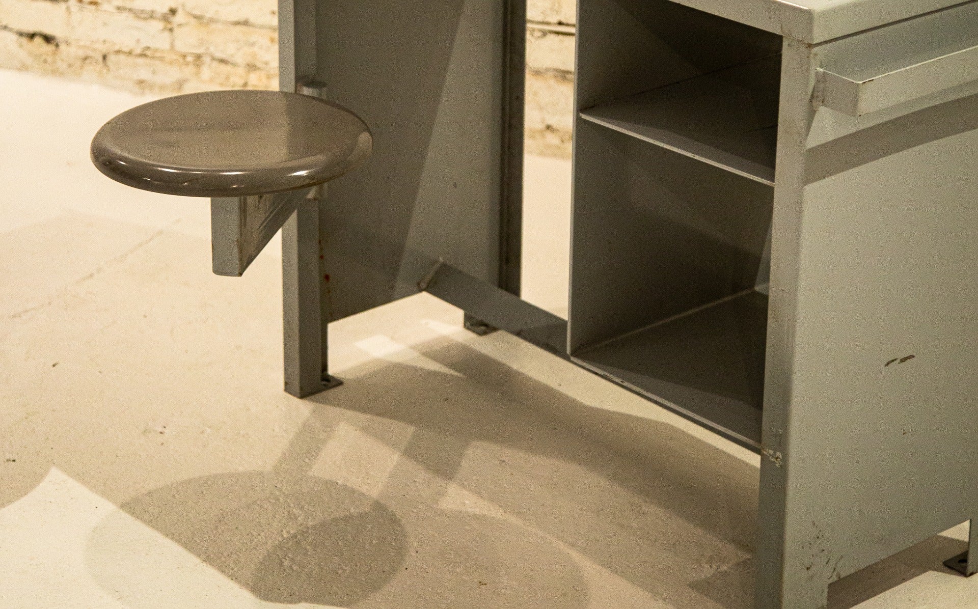 original 1950's vintage american industrial heavily reinforced solid steel cook county prison desk with swing-out seat