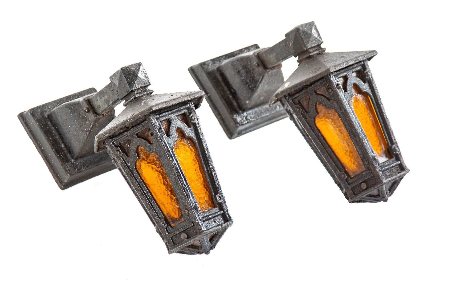matching set of hard to find tudor revival style exterior residential ornamental cast iron exterior wall sconces with original amber glass insets
