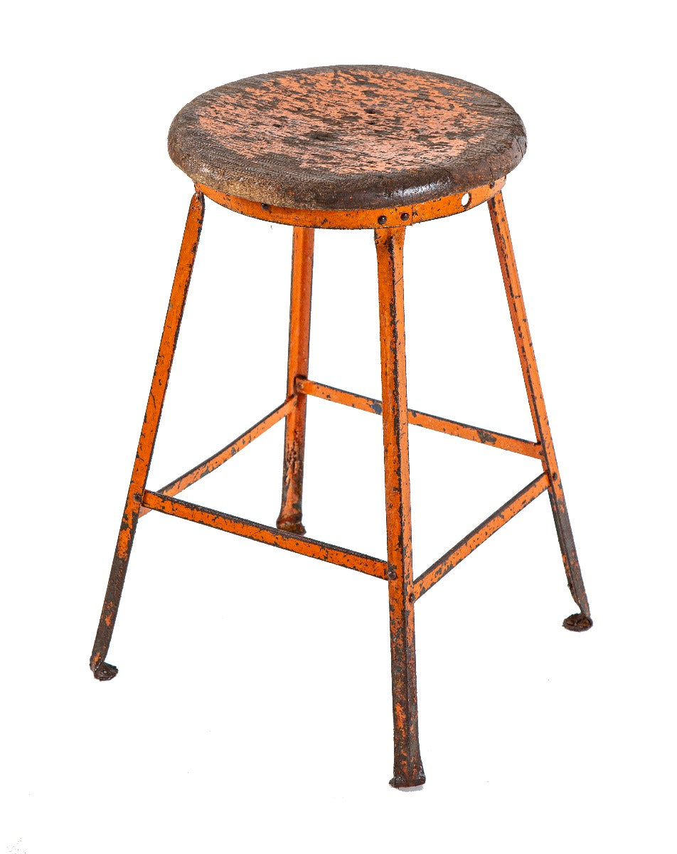 nicely worn and weathered four-legged riveted joint angled iron stool with old orange paint finish and original wood seat