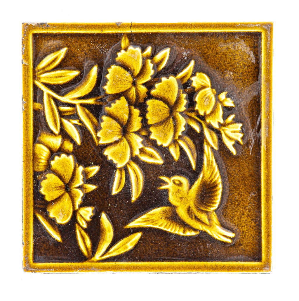 19th century salvaged figural 6 x 6 fireplace tile featuring floral designs and winged bird with rich olive glazed finish