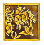 19th century salvaged figural 6 x 6 fireplace tile featuring floral designs and winged bird with rich olive glazed finish