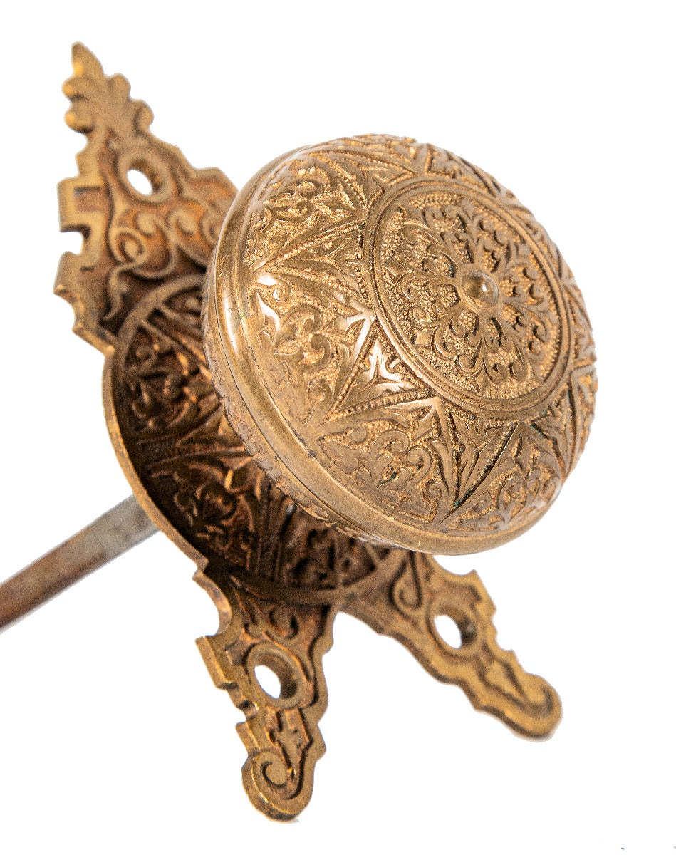 1870's oversized russell and erwin ornamental cast bronze doorknob with matching triangular-shaped backplate or rosette