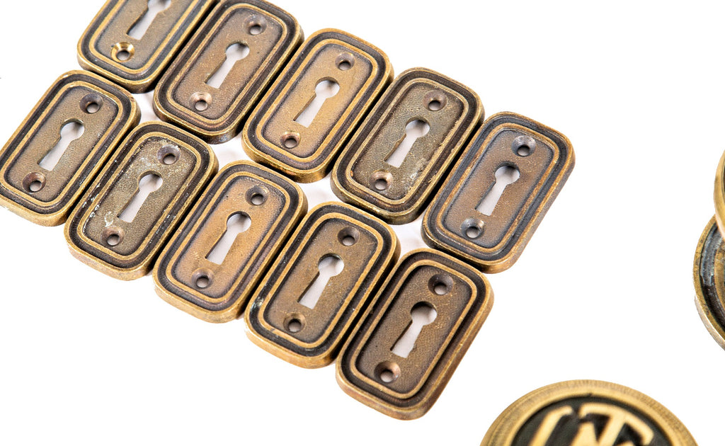 group of ten matching original 1920s logan square masonic temple cast brass monogrammed doorknobs with matching rosettes and keyplates