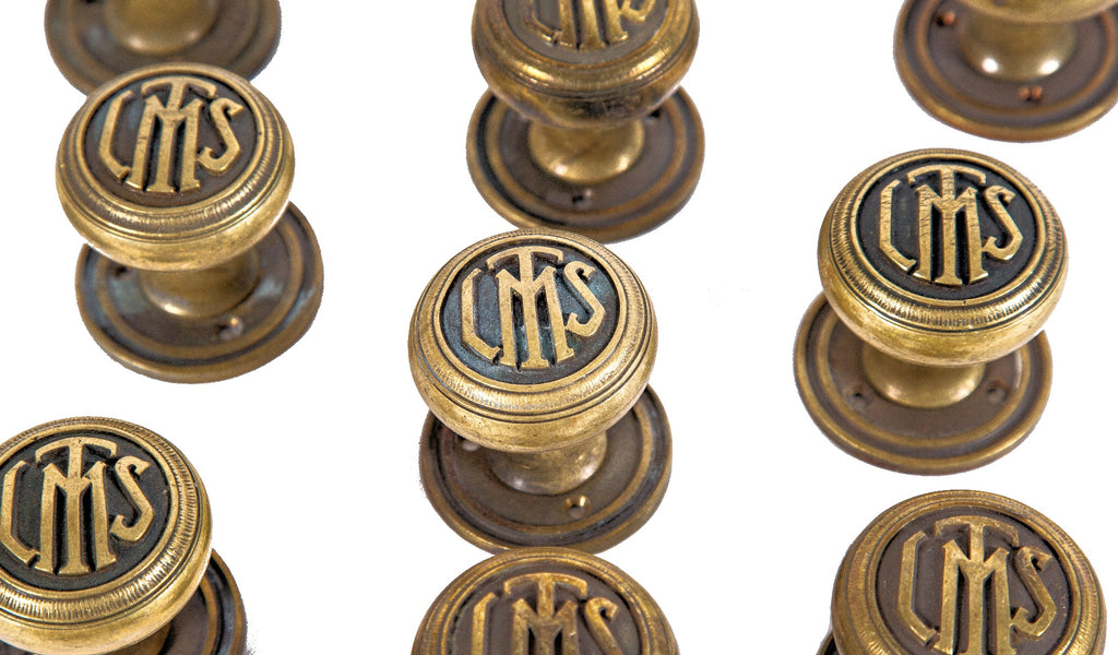 group of ten matching original 1920s logan square masonic temple cast brass monogrammed doorknobs with matching rosettes and keyplates