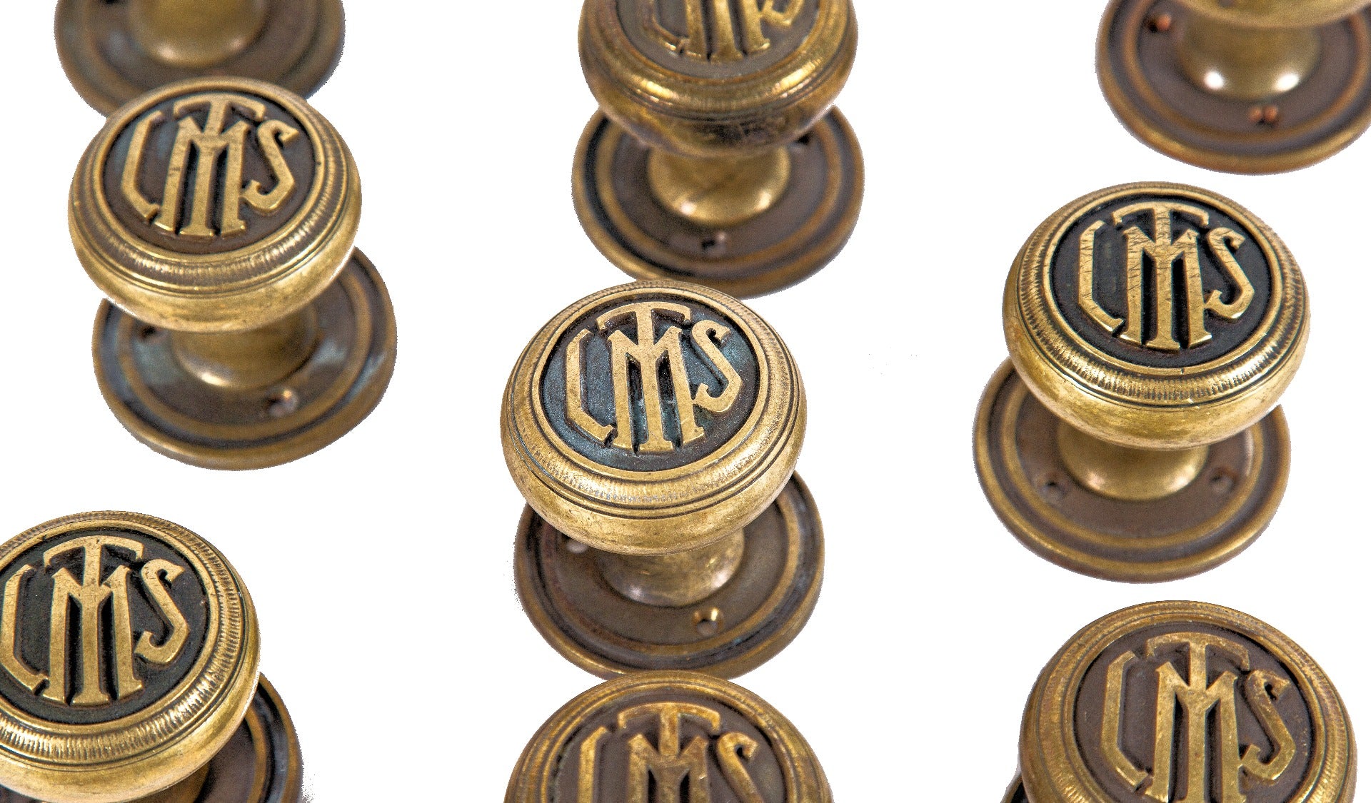 group of ten matching original 1920s logan square masonic temple cast brass monogrammed doorknobs with matching rosettes and keyplates