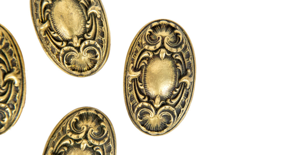 group of four matching ornamental cast brass salvaged chicago yale & towne "navarro" pattern doorknobs