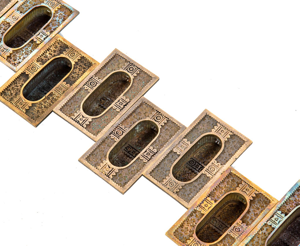 ten matching highly sought after ornamental cast bronze "ivy" pattern residential window sash pulls with nicely aged patina