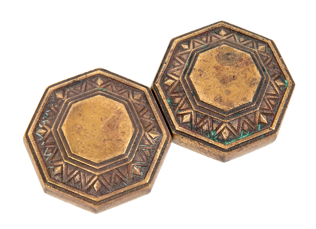 two matching original and highly sought after holabird and root-designed palmolive building art deco cast bronze doorknobs