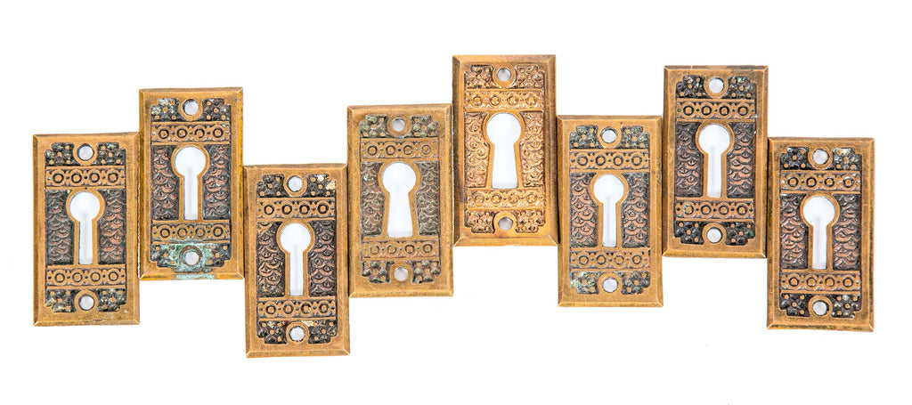 group of 8 matching highly desirable 19th century "brocade" pattern interior residential passage door keyplates