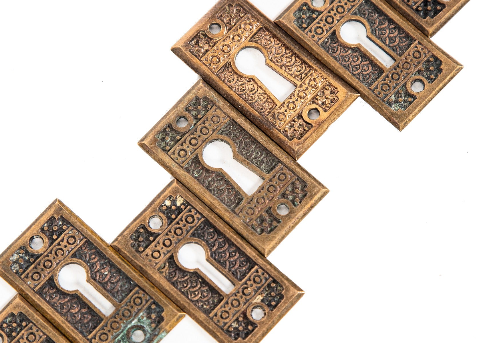 group of 8 matching highly desirable 19th century "brocade" pattern interior residential passage door keyplates